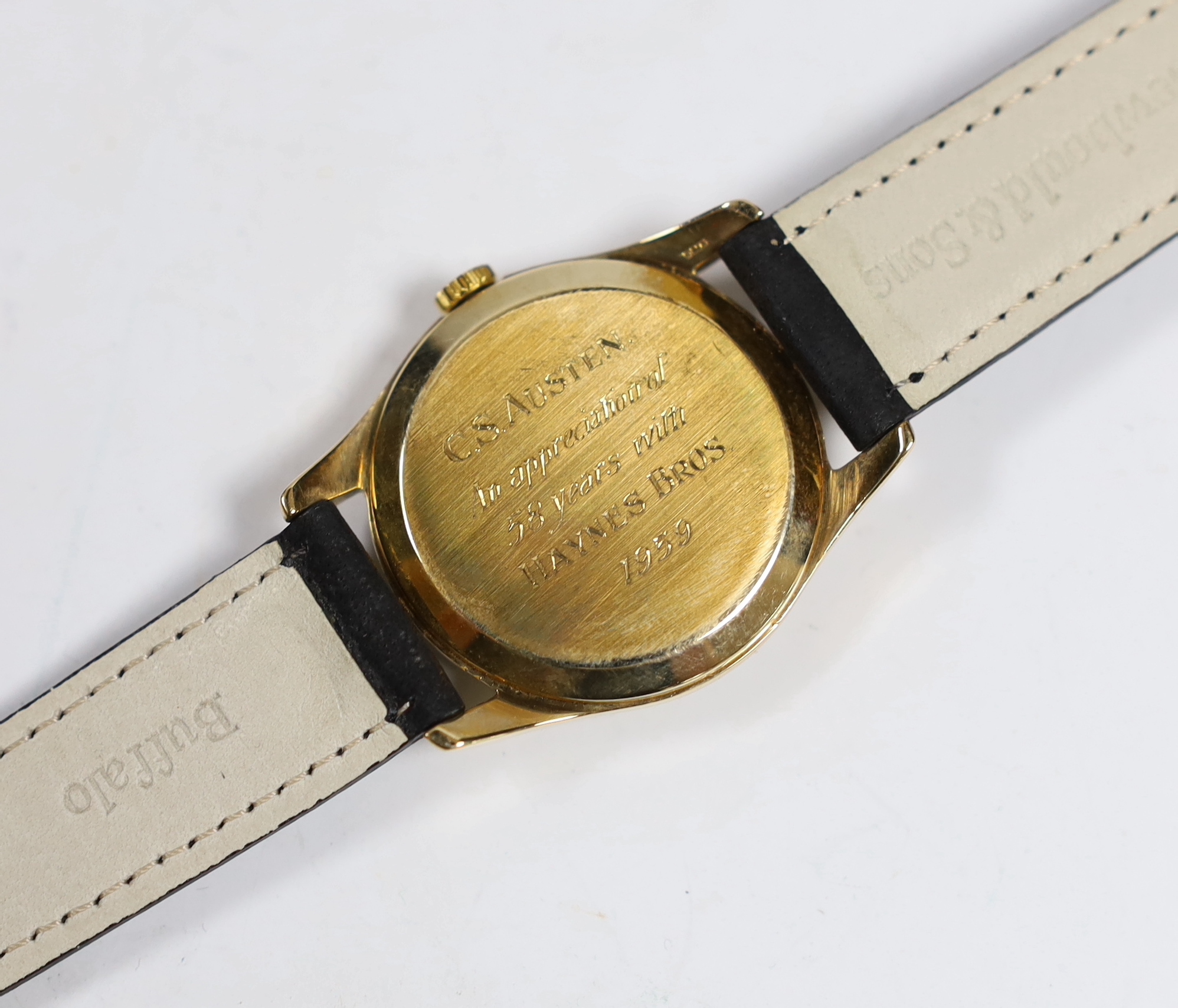 A gentleman's 9ct gold Omega manual wind wrist watch, with case back inscription, on associated leather strap, case diameter 34mm.